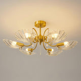 Shell shade ceiling light lit against a warm ceiling