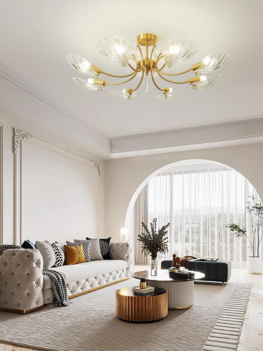 Shell shade ceiling light above a sofa beside an arched opening