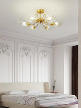 Shell shade ceiling light above a bed with a wood headboard