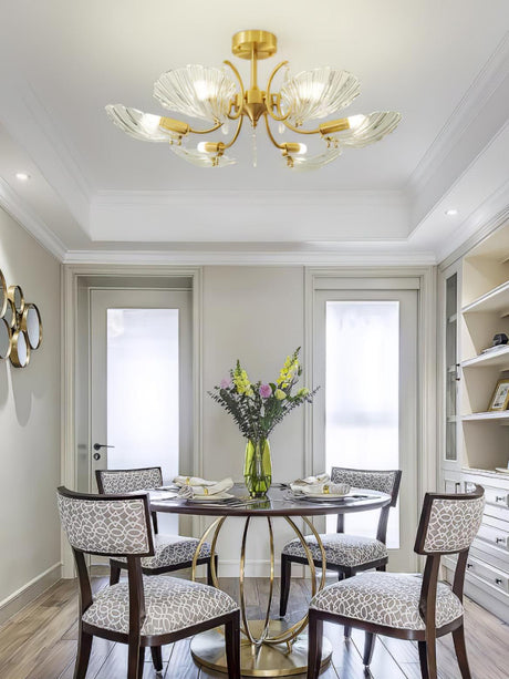 Shell shade ceiling light above a round dining table with chairs