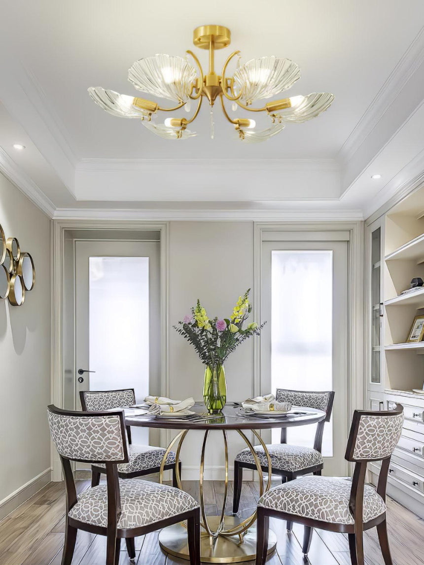 Shell shade ceiling light above a round dining table with chairs