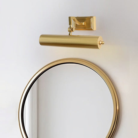 Brass tube lit above a round mirror in a dark frame on a pale wall