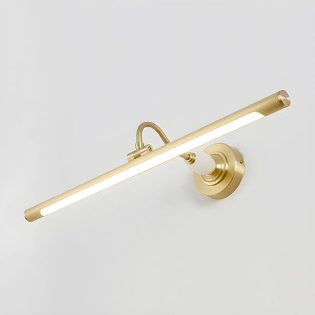 The brass version lit, the tube bright under its curved arm on a pale wall