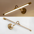 The darker bronze version lit against a warm ground, the arm curving to the plate