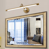 Brass bar lit above a gilt framed mirror reflecting a curtained window and a lamp