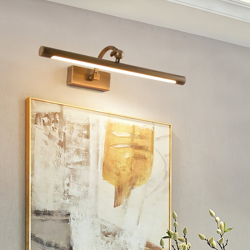Bronze bar lit close above a gilt framed canvas, the beam falling down the paint