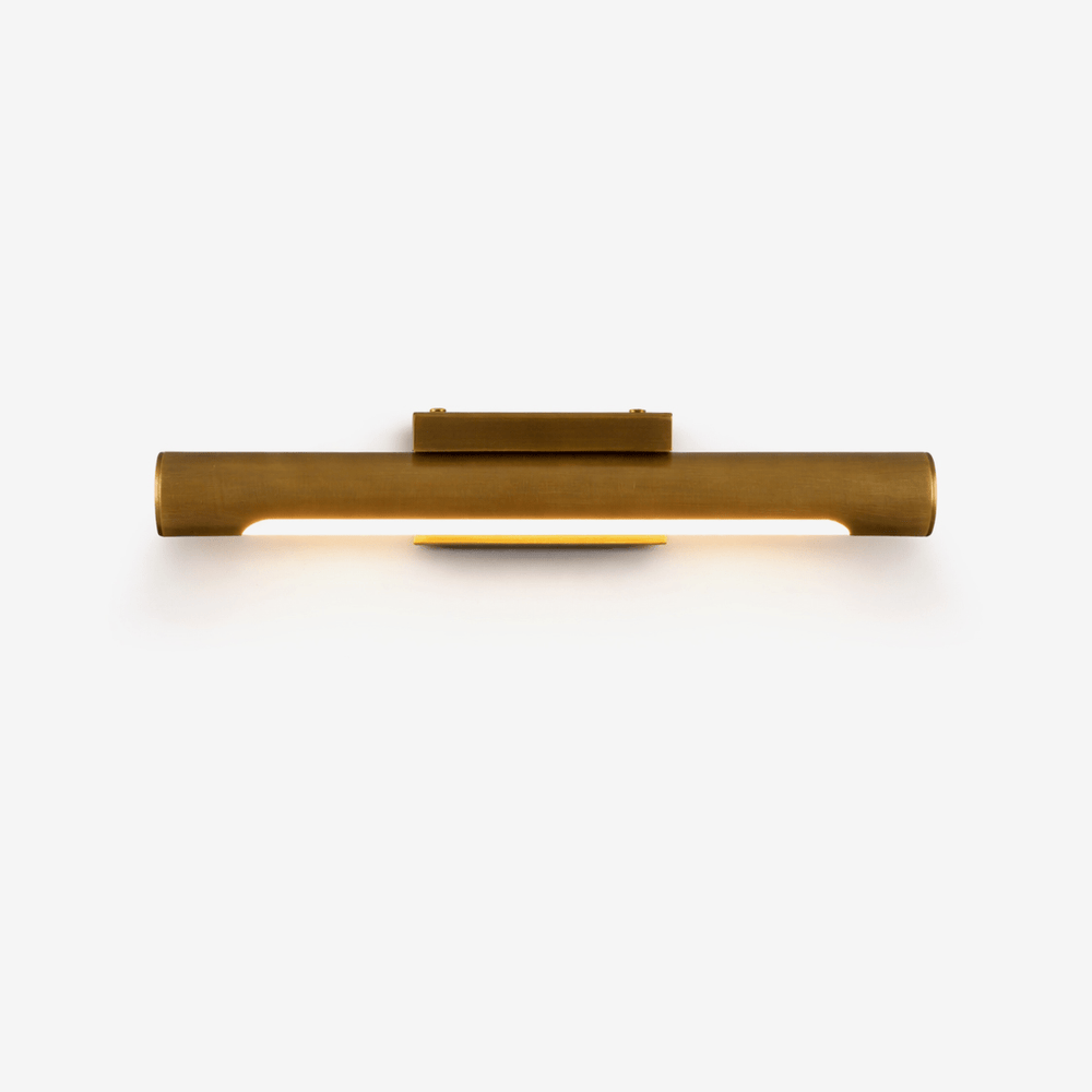 Slim bronze bar lit along its underside, a small block at its center
