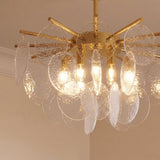 The same gold hub with clear bubbled glass discs hanging in overlapping tiers