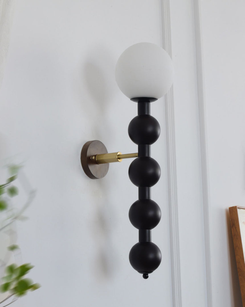 Close view of the stacked beads and the brass arm holding them out