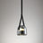 The gray plated glass shade on its leather strap on a plain backdrop
