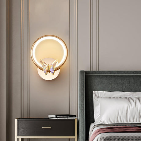 The butterfly ring lit above a nightstand beside a green headboard and striped linens