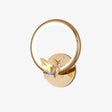 Gold ring wall light with an iridescent crystal butterfly resting on the round wall plate