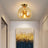 Metal and glass ceiling lamp for compact rooms