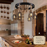 The fitting lit in a rustic kitchen above a counter and hanging pans
