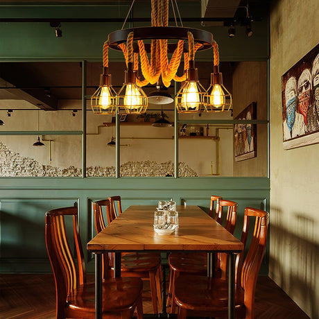 Chandelier lit above a long wood table with chairs on both sides