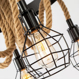 One black wire cage with a filament lamp burning inside it