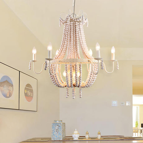 Hung above a table set with candles beside two framed prints on a white wall