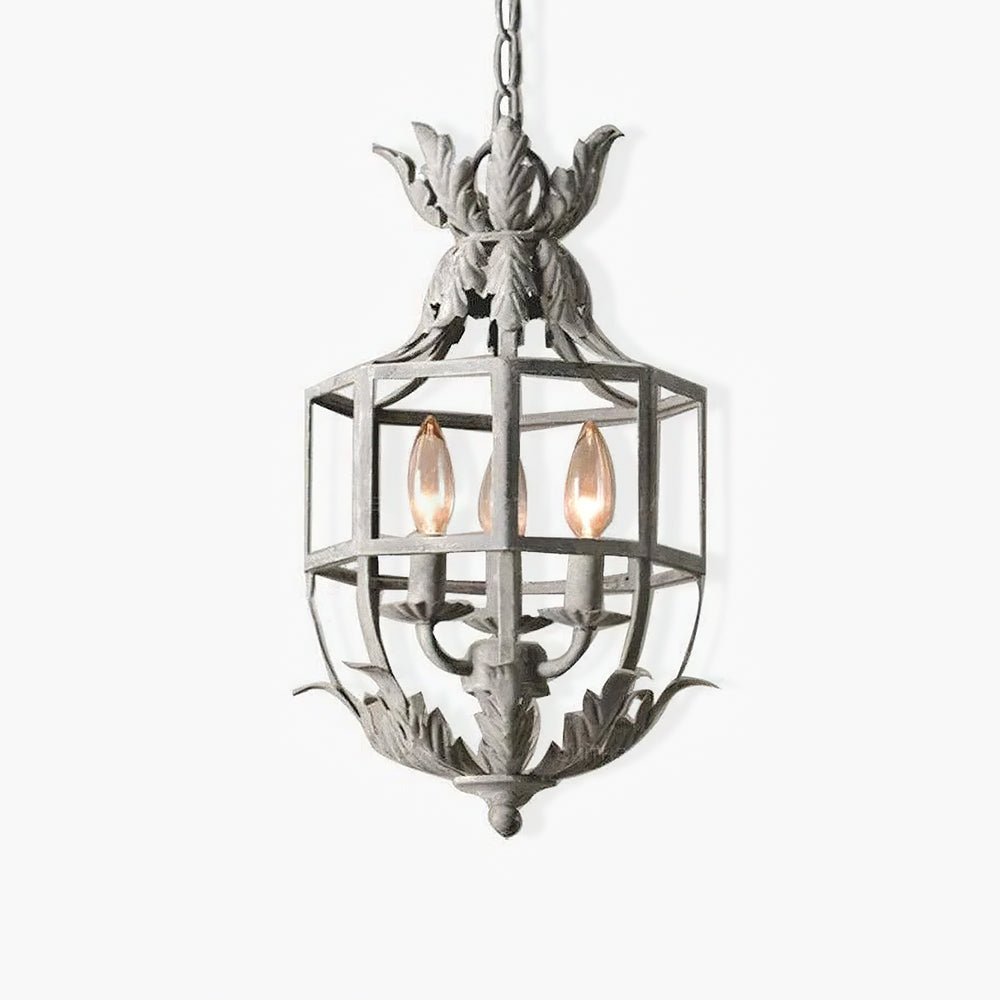 A pale metal cage lantern with a leaf crown on top and three candle lamps inside