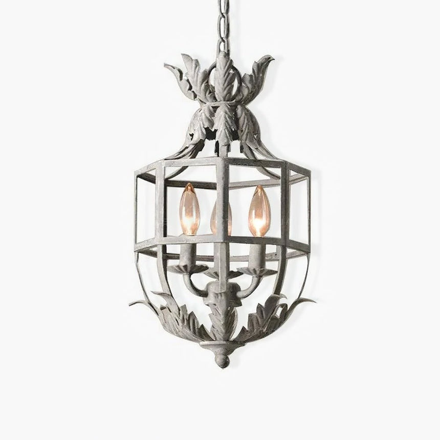 A pale metal cage lantern with a leaf crown on top and three candle lamps inside
