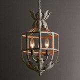The cage lit warm against a dark wall, leaf crown and base showing