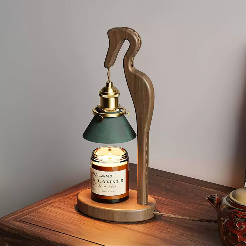 Close view of the lit green cone shade above the candle jar