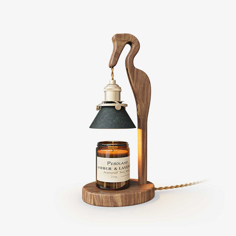 Candle warmer lamp with a carved walnut heron holding a green cone shade
