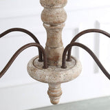 The turned wood column where the five bronze arms meet, sanded edges showing the grain