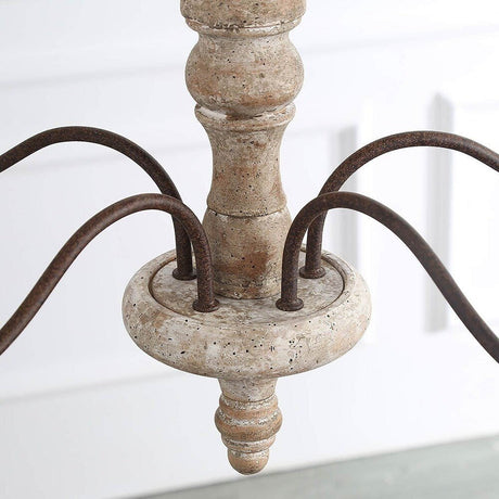 The turned wood column where the five bronze arms meet, sanded edges showing the grain