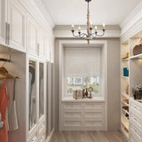Hung in a dressing room lined with open shelves and drawers in front of a shuttered window