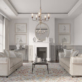 Seen from the doorway of a gray living room with a fireplace, two sofas and a patterned rug