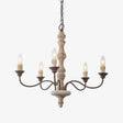Five dark bronze arms curving out of a turned pale wood column, candle sleeves upright