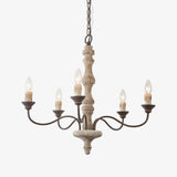 Five dark bronze arms curving out of a turned pale wood column, candle sleeves upright