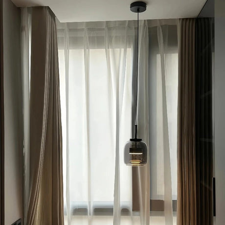Single glass shade in a room with long curtains