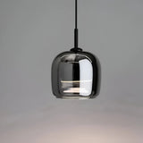 Ceiling light with a smoke gray glass shade on a pale wall