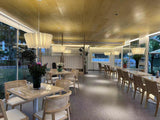 Row of pleated fabric shades above bench seating