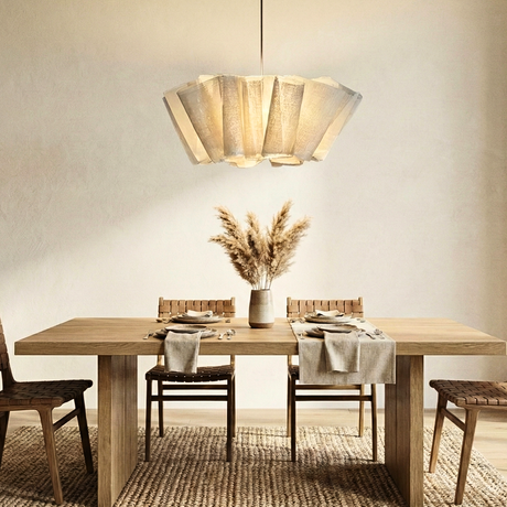 Pleated fabric shade above a wooden table with dried flowers