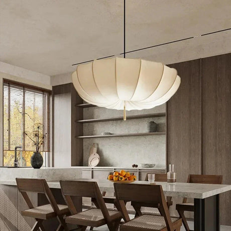 Scalloped cloth shade in a kitchen and dining room with dark wood