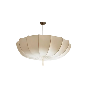 Scalloped cream cloth shade photographed against a plain gray ground