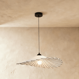 A wide flat fabric shade with a stitched scalloped edge on a black cord