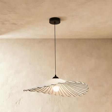 A wide flat fabric shade with a stitched scalloped edge on a black cord