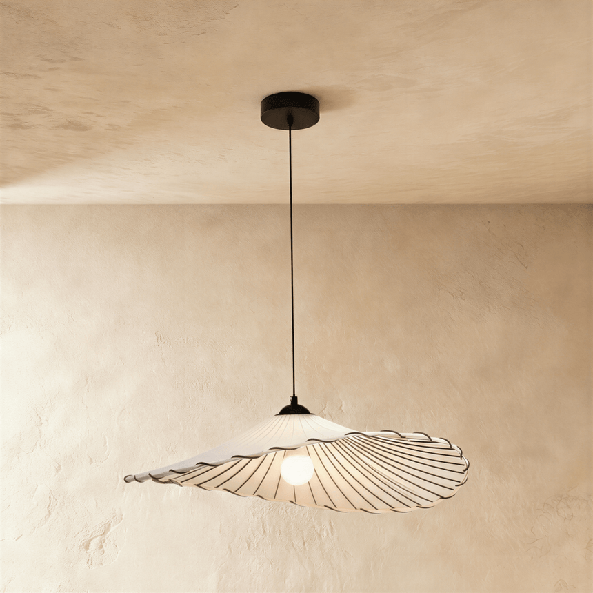 A wide flat fabric shade with a stitched scalloped edge on a black cord
