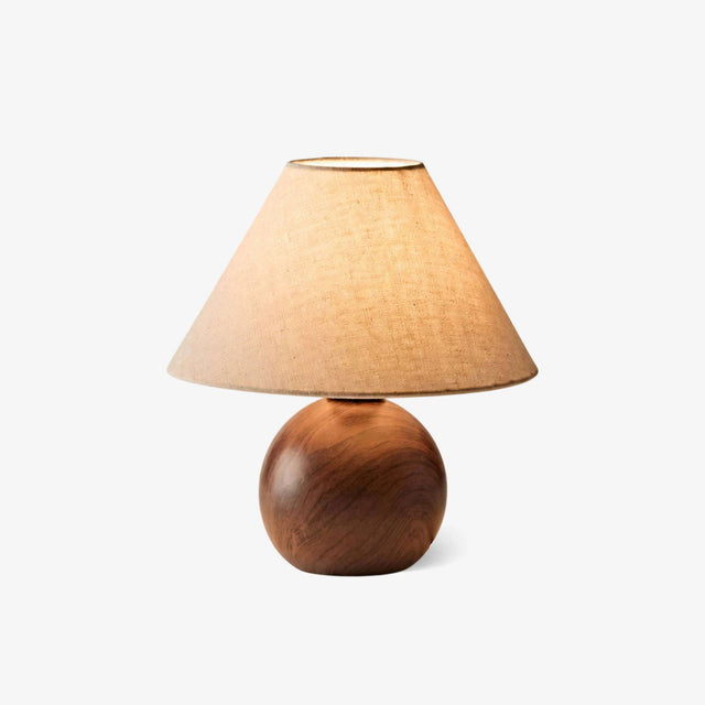 Ceramic bedside lamp with a linen shade on a wood grain orb, plain ground