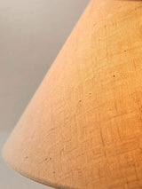 Close view of the linen weave of the shade lit from inside