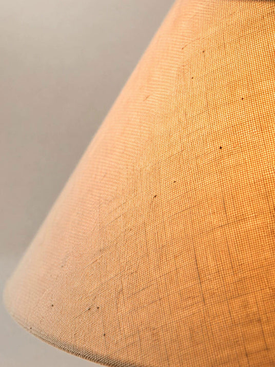 Close view of the linen weave of the shade lit from inside