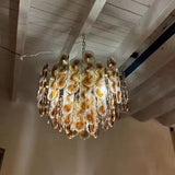 The chandelier seen from below hanging on its chain from the ceiling