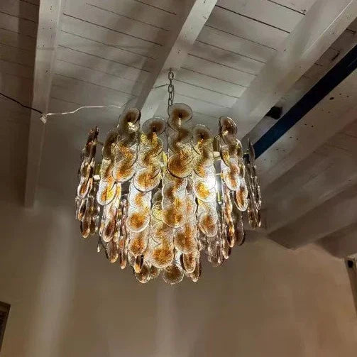 The chandelier seen from below hanging on its chain from the ceiling