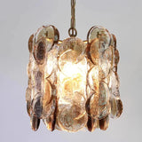 Close view of the overlapping amber glass petals on their metal frame