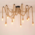 The open bulb version seen against a pale ceiling, rope arms spread wide