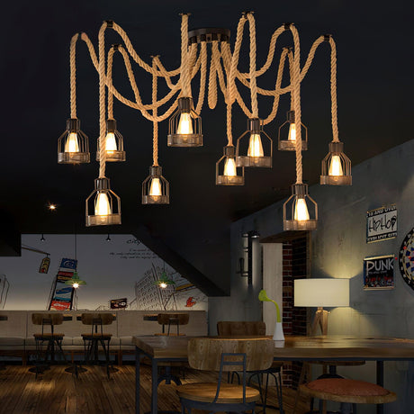 Lit above seating and tables in a room with a staircase and a mural behind
