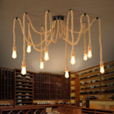 Lit above a room with wine shelving, a wood table and chairs below